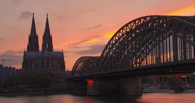 Establishing shot urban view. City skyline sunset at Cologne Cathedral with Rhine River and Hohenzollern Bridge