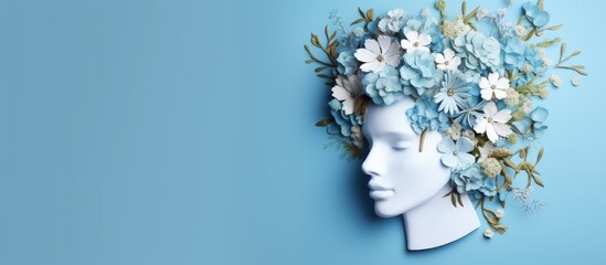 Image representing World Mental Health Day with paper head and flowers on blue background