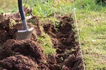 Installing borders in the garden, digging in the ground