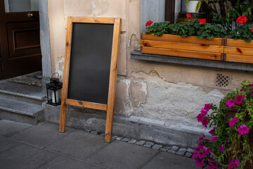 Empty wooden chalkboard on the street ready to fill