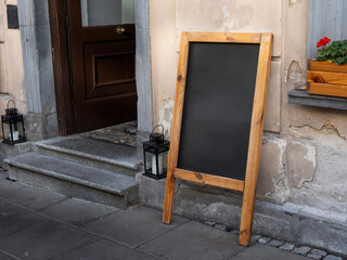 Empty wooden chalkboard on the street ready to fill
