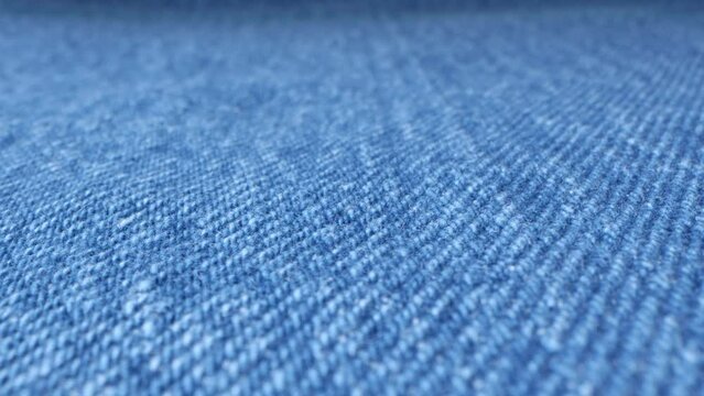 Macro shot of blue denim fabric. Casual wear material. Vintage texture surface