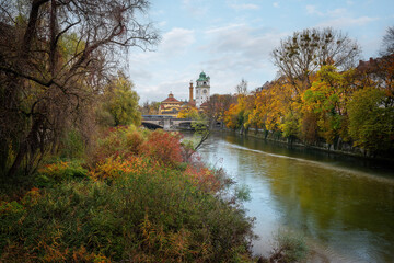 Fototapeta na wymiar Isar River during Autumn Season with Mullersches Volksbad - Munich, Bavaria, Germany
