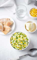 Cabbage cucumber corn salad in a bowl