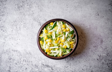 Cabbage cucumber corn salad in a bowl