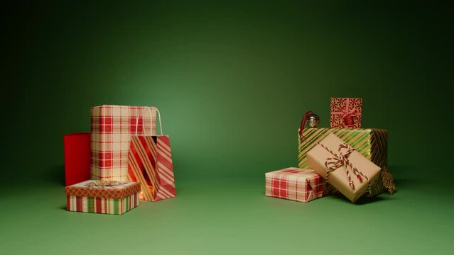 Dolly shot of two stacks of Christmas gifts with empty central section for copy isolated on green background. Concept of magical Christmas night, family love and care. Red and golden color gift wraps