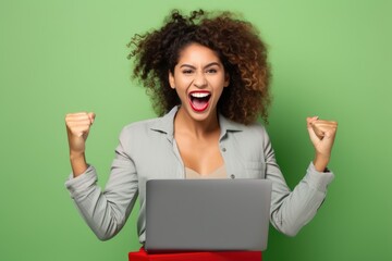 Euphoric Latin Businesswoman Holding Laptop - Online Success and Job Offer Celebration