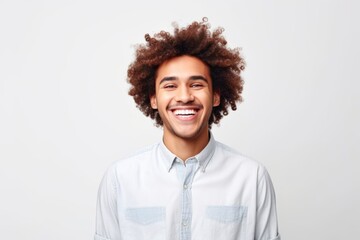 Fototapeta na wymiar Cheerful Curly Haired Guy: Positive Emotion Headshot on White