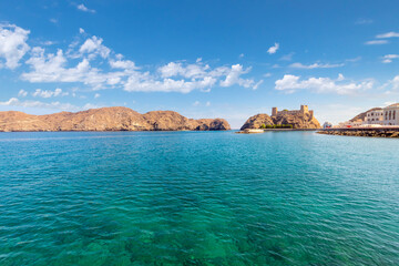 Seaside view of the Al Jalali Fort, an historic 1500s sea fort built by the Portuguese and used as both a jail and refuge for the Omani royals,rising above Gulf of Oman in Muscat, Oman. - obrazy, fototapety, plakaty