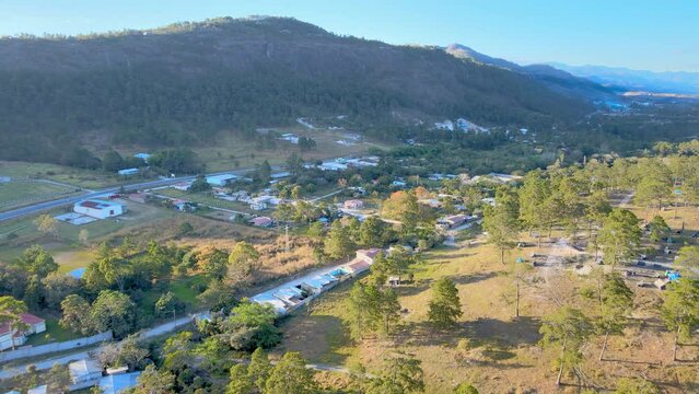 Aerial trip over a small town named Marcala with yellow sunset light