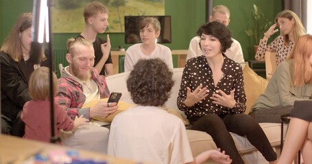 Activating audience By supporting with hand movements, she can stimulate activity participation young people in discussions tasks. Female speaker strongly speaks teaching method.