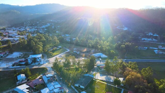 Idyllic view over a small town named Marcala City in Honduras and with sunset sunrays coming from top of a hill