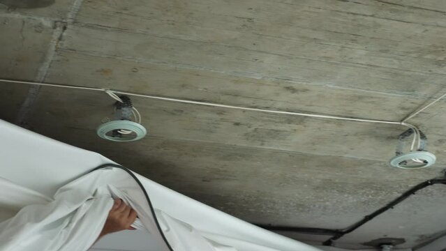 Installing and maintenance stretch ceiling in new flat. Construction of apartment