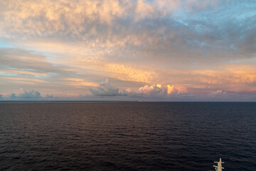 Naklejka na ściany i meble Dramatic cloud sky during sunrise/sunset over the North Atlantic Ocean and Caribean Sea looks like the sky is on fire.