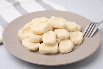 Fototapeta na wymiar Plate of tasty lazy dumplings on white table, closeup