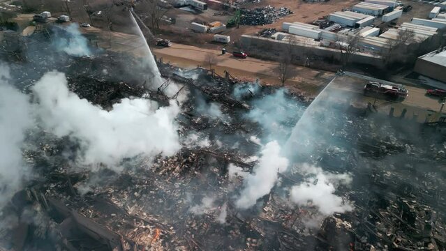 Above Drone view of firemen fighting with fire near biulding 