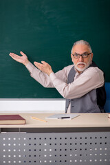 Old male teacher in the classroom