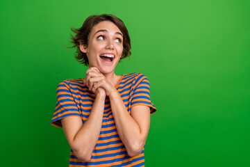 Photo of impressed cheerful girl hold folded arms palms look empty space open mouth isolated on...