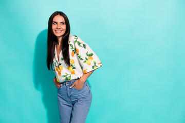 Portrait of good mood nice girl with straight hairdo wear stylish shirt look at promo empty space isolated on teal color background