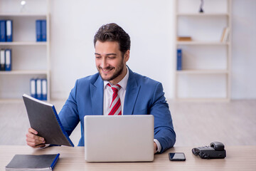 Young male employee working in the office