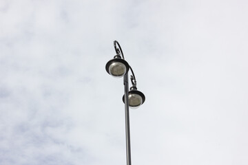 Fototapeta na wymiar Street lamp with glass shades. The street lamp is on.