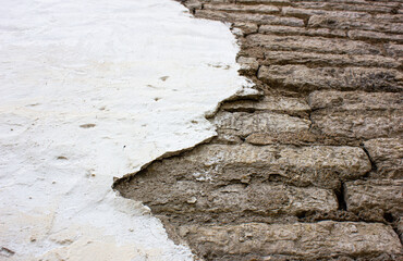 Old collapsed plaster. Damaged plastered wall.
