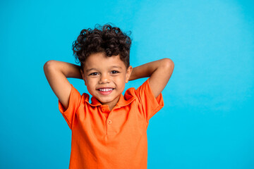 Photo of kid boy hands over head relax after school day isolated blue color background