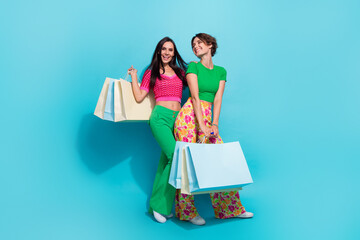 Full body length cadre of two models posing charming lgbt couple bring packages shopping center...