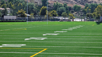 Low angle view of yard markers on American football field.