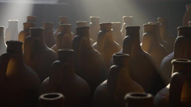 Close-Up Panning Shot Of Sunlight Falling On Pitchers In Workshop - Cappadocia, Turkey