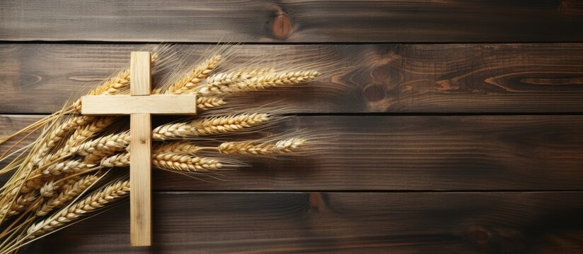 Wheat on wooden desk with wooden cross
