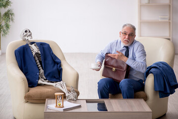 Old businessman meeting with skeleton in business meeting concep