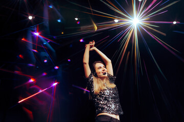 Beautiful Woman Performing on a Stage at her Own Show. Musical artist doing choreography routing...