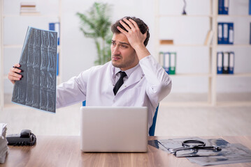 Young male doctor radiologist working in the clinic