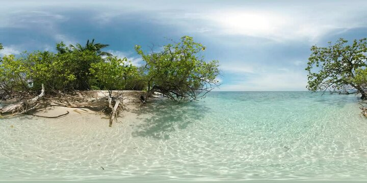 Clear ocean waves over white sand beach in Mantigue Island. Blue sky and clouds. Camiguin, Philippines. VR 360.