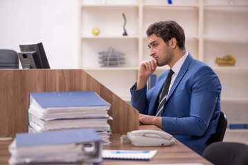 Young male employee working in the office