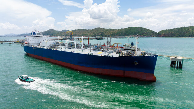 crude oil floating station in sea, bridge pipeline load unloading crude oil from oil ship transport, industry business transportation by container ship open sea