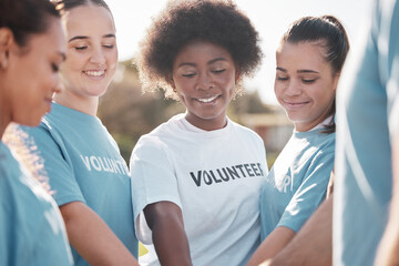 Diversity, smile and a volunteer group in a huddle outdoor for charity, community or activism together. Teamwork, climate change and recycling with eco friendly people in the park for a green planet