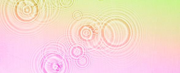 Fototapeta na wymiar Circles and waves on water of coral rainbow color in sunlight