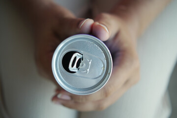 slow motion of opening a soft drinks can .