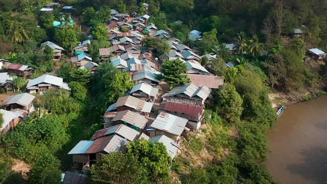 Longneck karen village in the mountain with boat on the river. Mae Hong Son, Thailand. Aerial Shot