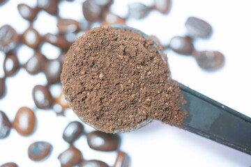 Ground coffee in a coffee measuring spoon