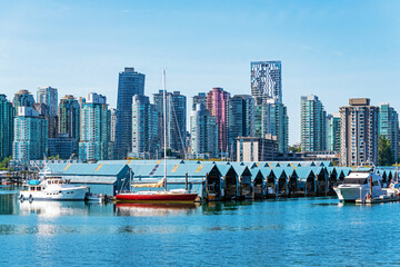 Yacht club with roofed construction for ships seen from Seawall of Stanley Park with downtown...