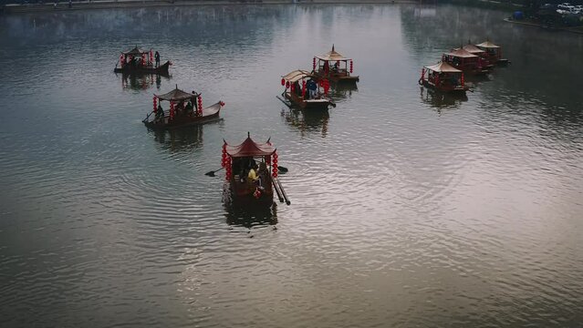 Asian chinese boat with mist on a lake in Thailand. Aerial shot forward 