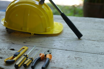 Fototapeta premium Set of professional construction tools and safety helmet on work table. Top view. Old tools. Various tools on a wooden table