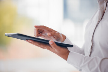 Fototapeta premium Woman, hands and tablet in research, networking or social media for online communication at office. Closeup of female person or employee with technology in browsing, web search or design at workplace