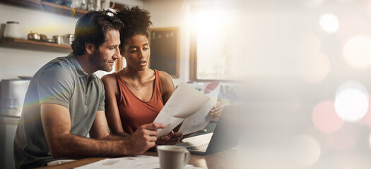 Laptop, space and an interracial couple in their home for budget planning or finance investment accounting. Documents, mockup or banner with a man and woman reading bank information for savings