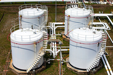 Tank farm in industry Thailand with white oil and petrol silos under