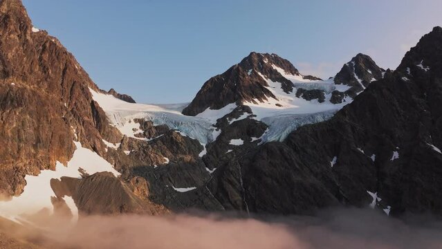 Sun-Drenched Steep Canyons near Tromso with Lyngen Alps