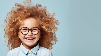 The 5 year old girl with curly blonde hair is happy with her new glasses. Isolated on studio background - obrazy, fototapety, plakaty